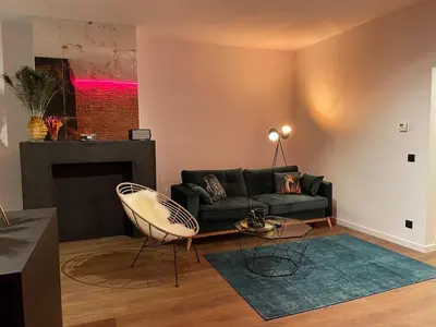a living room with a couch and a fireplace at The Green Gatsby in Antwerp