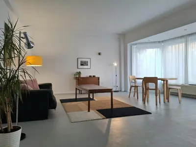 a living room with a couch and a table and chairs at Spacious next to Grand Place in Brussels