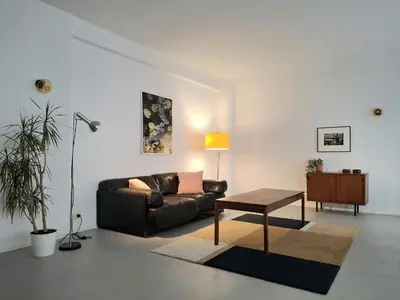 a living room with a couch and a table at Central in the heart of Brussels in Brussels