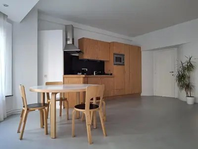 a kitchen and dining room with a table and chairs at Central in the heart of Brussels in Brussels