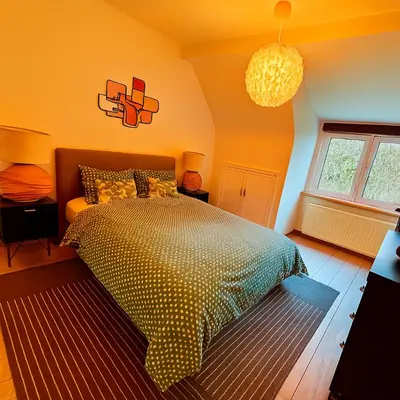 a bedroom with a bed and a window at Brussels Quiet Oasis in Brussels