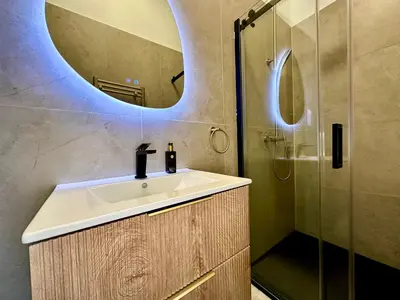 a bathroom with a sink and a shower at Luxury Suites Royal by Rikas Hotels in Antwerp