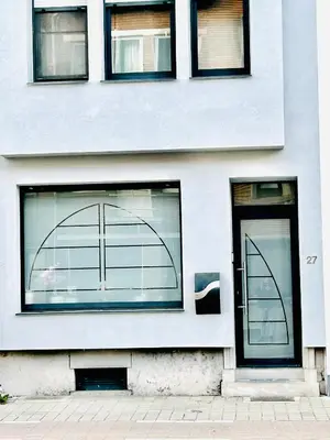 a white building with windows and a door at The Nest In Leuven -Cosy room near Brussels in Leuven