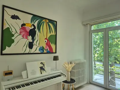 a room with a piano and a painting on the wall at Souverain 94 in Brussels