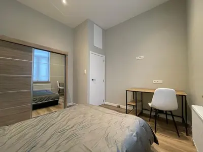a bedroom with a bed and a desk with a chair at Midi Station 2 in Brussels