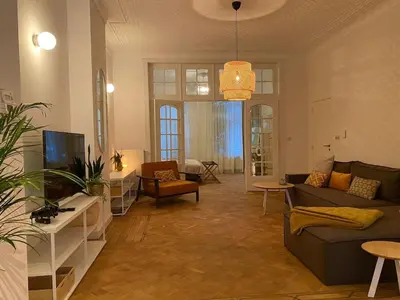a living room with a couch and a tv at Completely renovated apartment in Antwerp