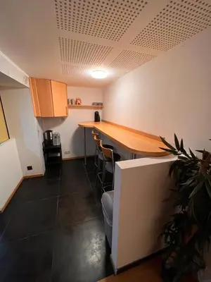 a kitchen with a table and chairs in a room at Doppelzimmer im Herzen Brüssels in Brussels