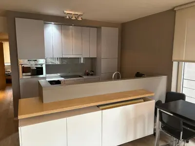 a kitchen with white cabinets and a counter top at Sleep & Explore Brussels in Brussels