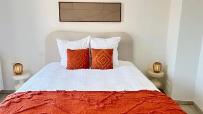 a bedroom with a bed with red and white pillows at Apartment for 6 people - near Brussels & Airport in Wezembeek-Oppem
