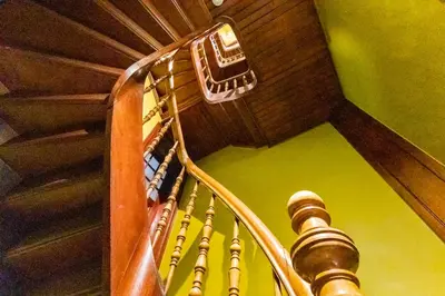 a wooden spiral staircase with a wooden ceiling at Boutique Cogels Osy Suite Four Garden in Antwerp