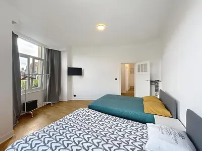 a bedroom with two beds and a window at Sacre-coeur Brussels 1 in Brussels