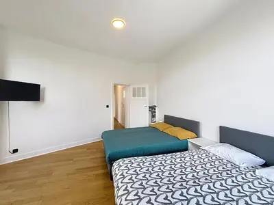 a bedroom with a bed and a flat screen tv at City Brussels 5 in Brussels