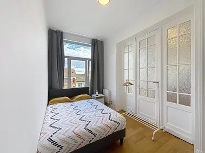 a bedroom with a bed and a window at City Brussels 5 in Brussels