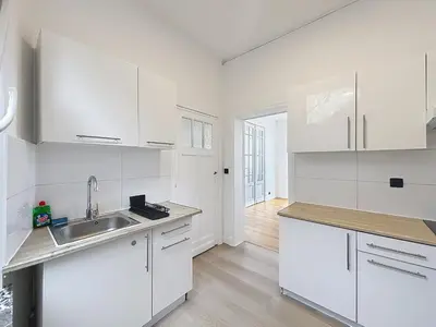 a white kitchen with white cabinets and a sink at City Brussels 5 in Brussels