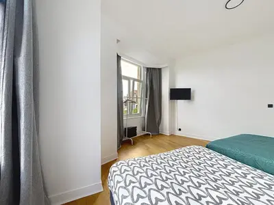 a bedroom with a bed and a window at Leopold Brussels 6 in Brussels