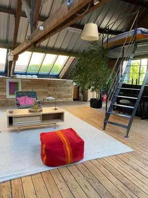 a living room with a red rug on the floor at The Urban Loft in Brussels West in Brussels