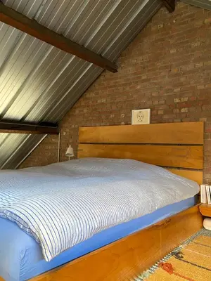 a bed in a room with a brick wall at The Urban Loft in Brussels West in Brussels