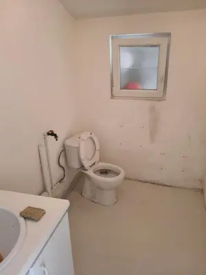 a bathroom with a toilet and a window at Ontferming RwinteR in Mol
