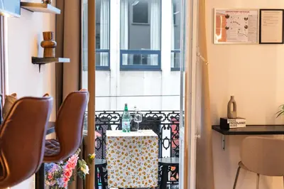 a room with a table and chairs and a window at Spacious & Stylish 3 adjacent Bedrooms Stay in Central Ghent in Ghent