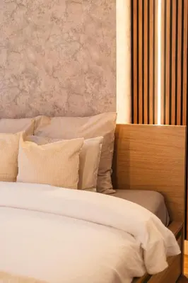 a bed with white sheets and pillows in a room at Spacious & Stylish 3 adjacent Bedrooms Stay in Central Ghent in Ghent