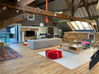 a large living room with a couch and a table at Urban Loft in Brussels West in Brussels