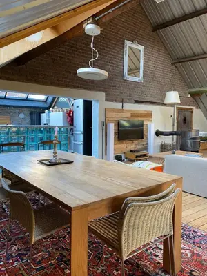 a wooden table and chairs in a living room at Urban Loft in Brussels West in Brussels