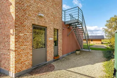 a brick building with a staircase on the side of it at Klavertje Lier Pallieter in Lier