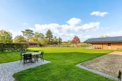 a patio with a table and chairs in a yard at Klavertje Lier Pallieter in Lier