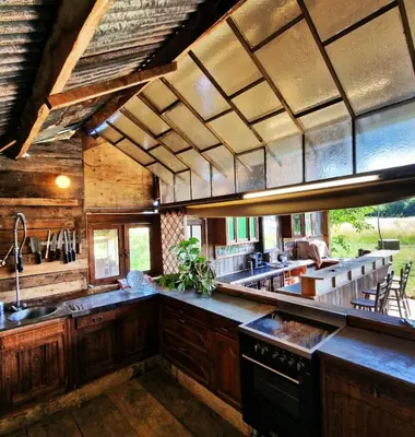 a large kitchen with wooden cabinets and a large counter top at Strackxhoeve Yurt 'Haardpeer' in Laakdal