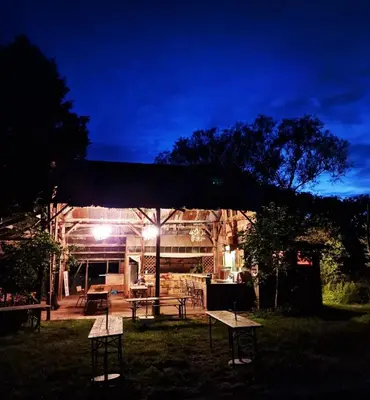 a group of picnic tables in a yard at night at Strackxhoeve Yurt 'Haardpeer' in Laakdal