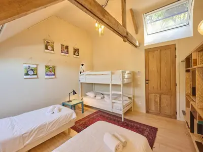 a bedroom with two bunk beds and a window at Lactea in Schilde