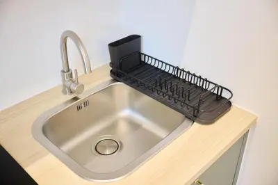 a kitchen sink with a keyboard on top of it at Apartment Duden 1 in Brussels