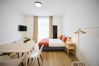 a bedroom with a bed and a table and chairs at Apartment Berthelot 5 in Brussels