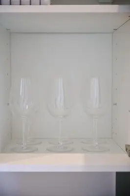 four wine glasses sitting on a white shelf at Apartment La Barrière 6 in Brussels