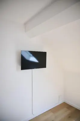 an installation view of a white wall with a spotlight on it at Apartment La Barrière 6 in Brussels