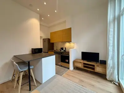 a kitchen with a table and a counter top at Urban Nest - Brussels in Brussels