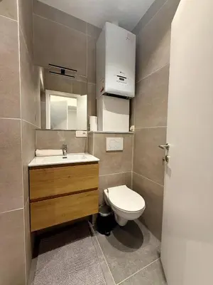 a small bathroom with a toilet and a sink at Urban Nest - Brussels in Brussels