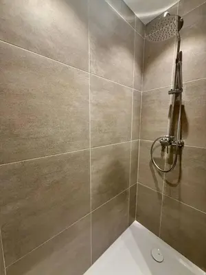 a bathroom with a shower and a toilet at The Modern Nest - Jourdan in Brussels