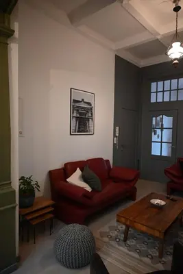 a living room with a red couch and a table at P60 Character & Comfort in 1000 Brussels in Brussels