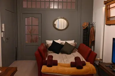 a bedroom with a bed with red chairs and a mirror at P60 Character & Comfort in 1000 Brussels in Brussels