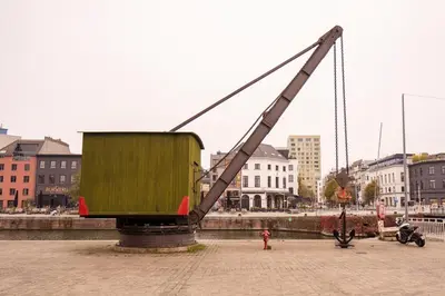 a large dumpster being lifted by a large crane at SHWAY - The Second Mate's Glance in Antwerp