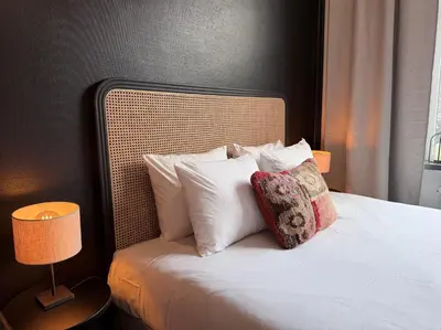 a bedroom with a bed with white pillows at Cosy 2-Room Apartment for 4 Guests near Gent Sint-Pieters Station, and Close to the City Centre in Ghent