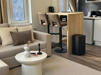 a living room with a couch and a table at Lovely 1BR & 1LR Apartment, Only 15 Min Walk to City Center in Ghent