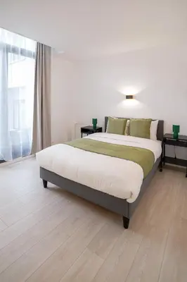 a bedroom with a large bed in a room at Malbeek 7 in Brussels