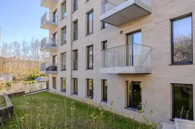 an apartment building with balconies and a yard at Stay at Brussels studio apartment in Brussels