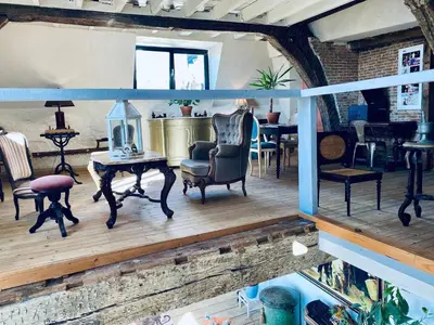a living room with chairs and a table with a lamp at The Mystical Suite in Antwerp