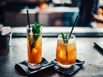 two cocktails sitting on top of a table at Stay with Beach and Minigolf Views in Ravels