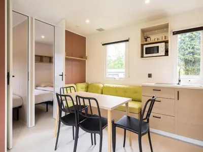 a kitchen and dining room with a table and chairs at Cordelia Lodge with Garden & Picnic Area in Ravels