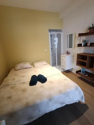 a bedroom with a bed with two hats on it at Studio charmoso in Brussels