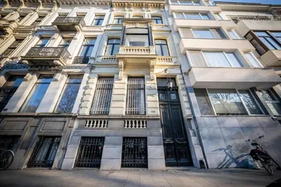 a building with a bunch of windows on it at Le Nymphale Suite Antwerp in Antwerp